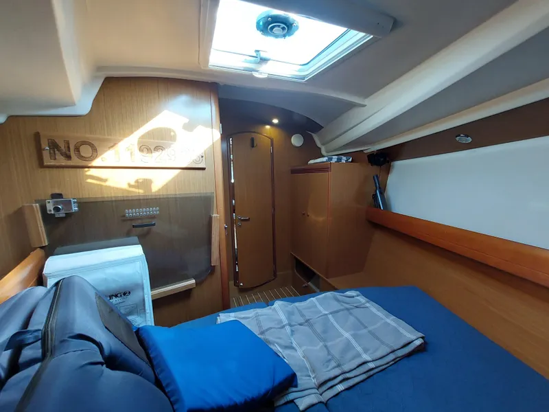 Slide: The Image of Interior cabin of 2006 Jeanneau Sun Odyssey 42 DS sailboat, featuring cozy bedding and wooden finishes. - 38