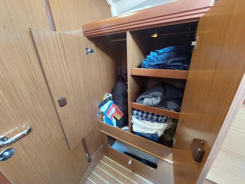Slide: The Image of Wooden closet with folded clothes inside a 2006 Jeanneau Sun Odyssey 42 DS yacht. - 39