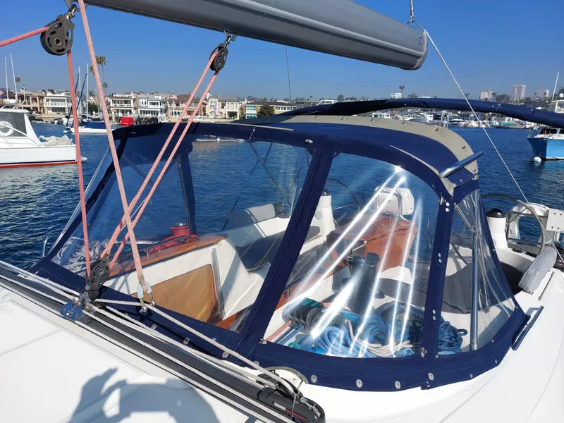 Slide: The Image of 2006 Jeanneau Sun Odyssey 42 DS sailboat with blue canopy in a marina. - 47