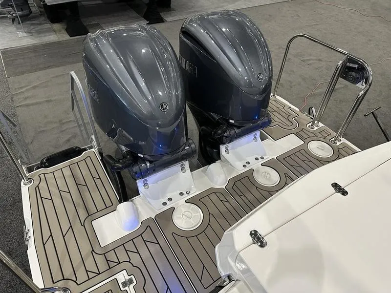 Slide: The Image of 2025 Cutwater C-32 CB LE boat with dual outboard engines on deck. - 10
