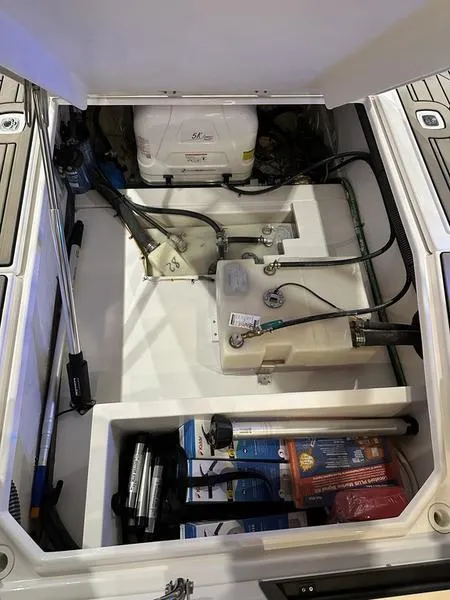 Slide: The Image of 2025 Cutwater C-32 CB LE boat storage compartment with equipment and supplies. - 12