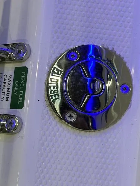 Slide: The Image of 2025 Cutwater C-32 CB LE diesel fuel cap with blue lighting. - 14