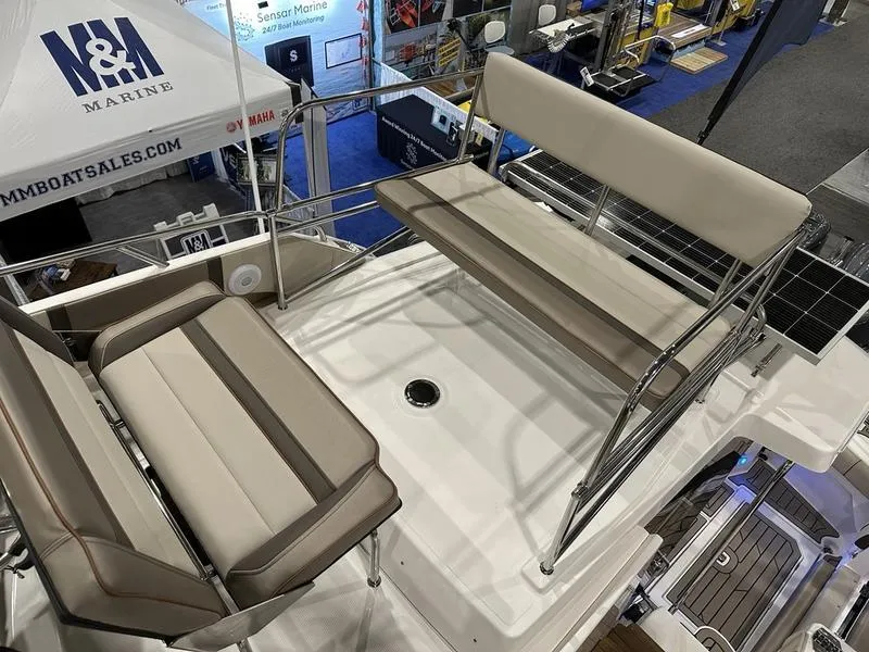 Slide: The Image of 2025 Cutwater C-32 CB LE boat deck with cushioned seating and railing. - 15