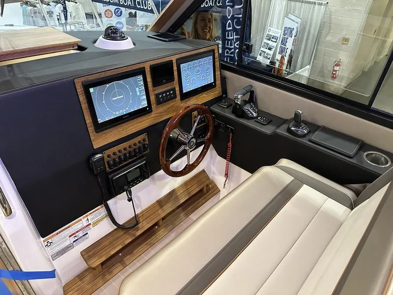 Slide: The Image of Interior helm of 2025 Cutwater C-32 CB LE boat with modern navigation displays. - 20