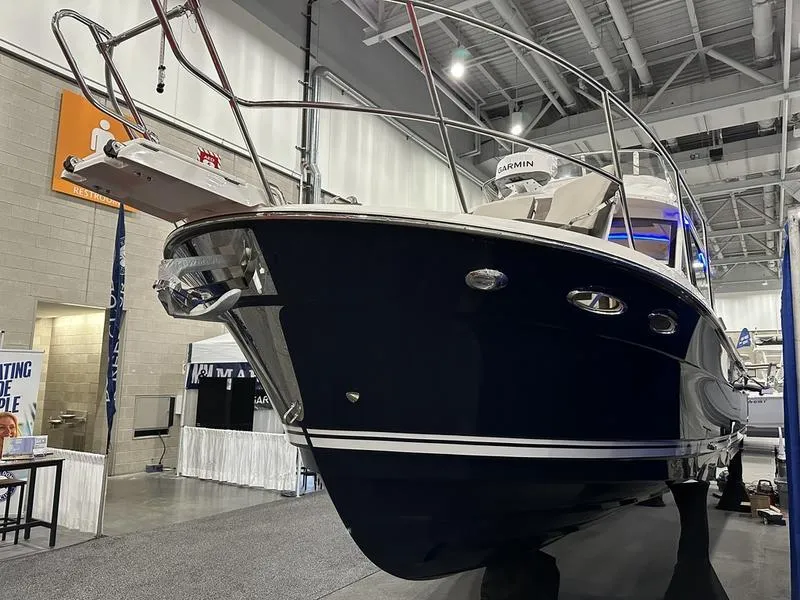Slide: The Image of 2025 Cutwater C-32 CB LE boat displayed at an indoor exhibition. - 3