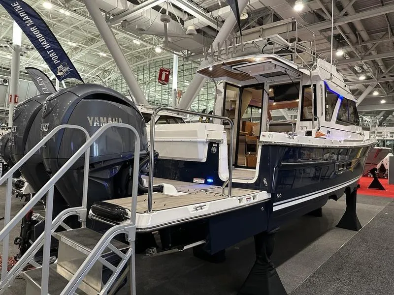 Slide: The Image of 2025 Cutwater C-32 CB LE boat displayed indoors with Yamaha engine. - 4