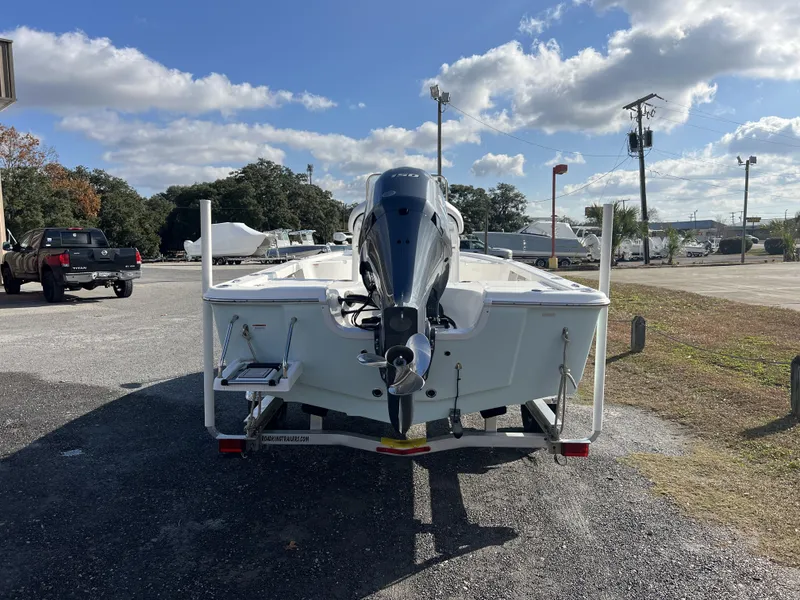 Slide: The Image of 2023 Sea Pro 208 Bay boat on trailer, parked outdoors under cloudy sky. - 5