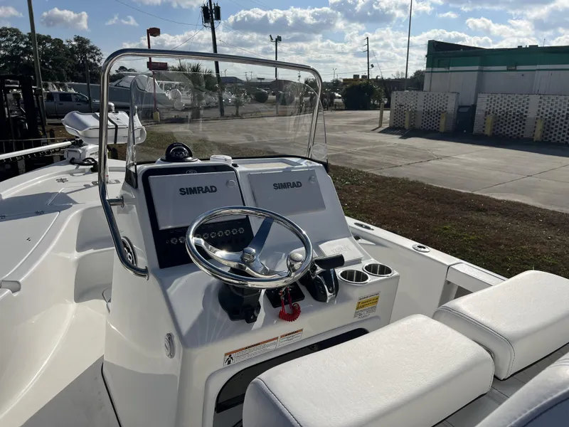 Slide: The Image of 2023 Sea Pro 208 Bay boat dashboard with Simrad electronics and steering wheel. - 6