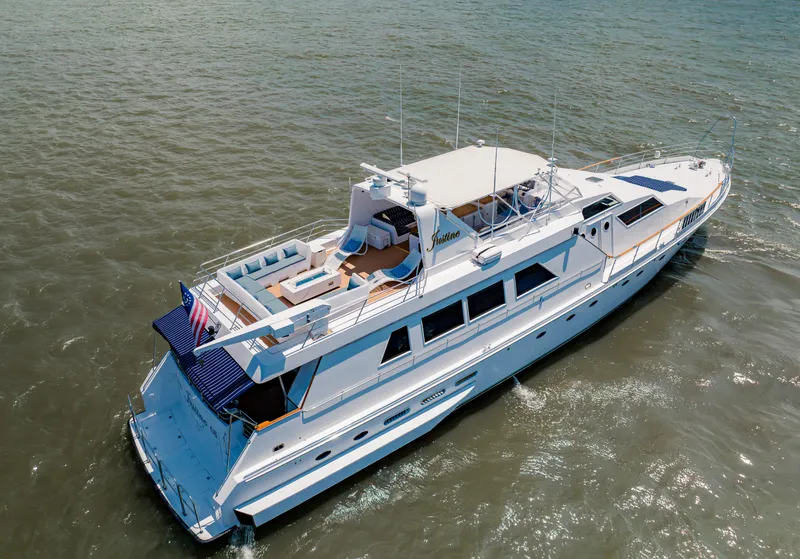 Slide: The Image of Luxury 1987 Guy Couach 97 yacht cruising on open water, aerial view. - 11