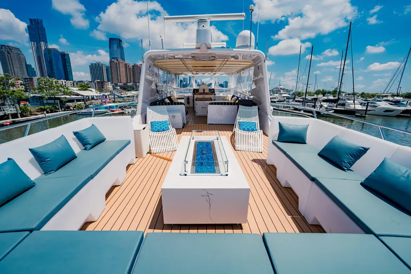 Slide: The Image of Luxurious 1987 Guy Couach 97 yacht with spacious deck seating and marina view. - 13