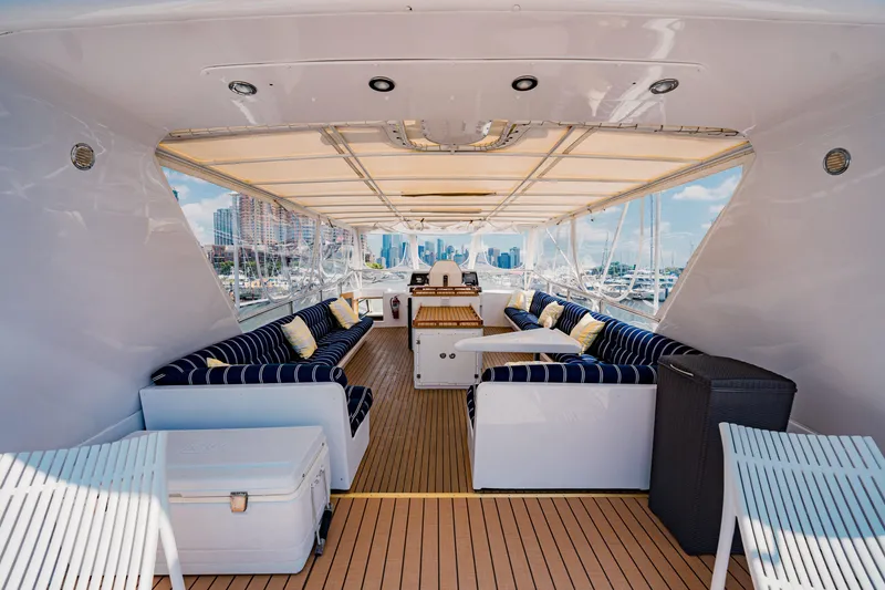 Slide: The Image of Luxurious 1987 Guy Couach 97 yacht interior with elegant seating and scenic marina view. - 17