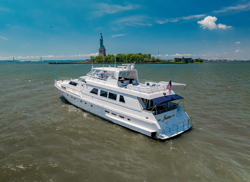 Slide: The Image of Luxury yacht Guy Couach 97 (1987) cruising near the Statue of Liberty on a sunny day. - 2