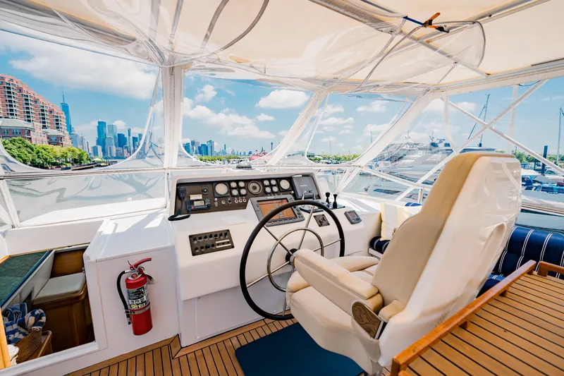 Slide: The Image of Helm of 1987 Guy Couach 97 yacht with city skyline view. - 20