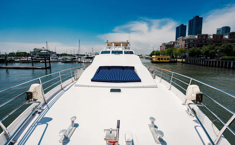 Slide: The Image of Luxurious 1987 Guy Couach 97 yacht docked in a scenic marina with city skyline. - 21