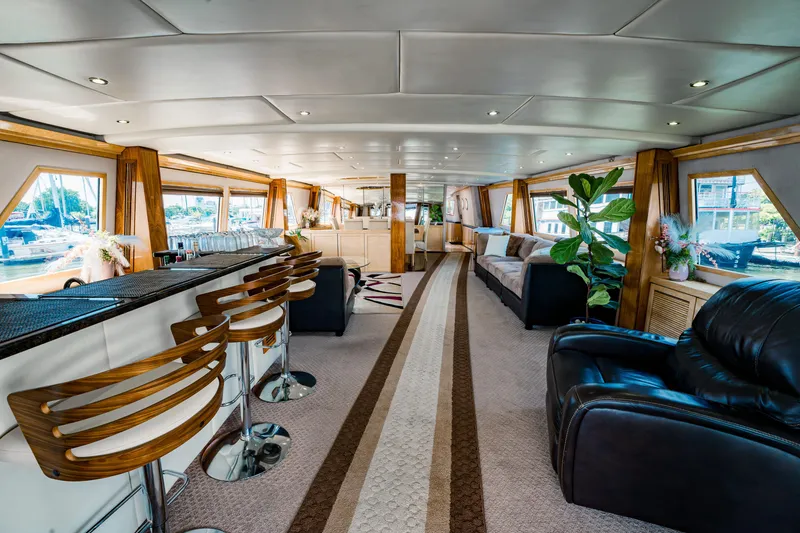 Slide: The Image of Luxurious interior of a 1987 Guy Couach 97 yacht with modern seating and elegant decor. - 25