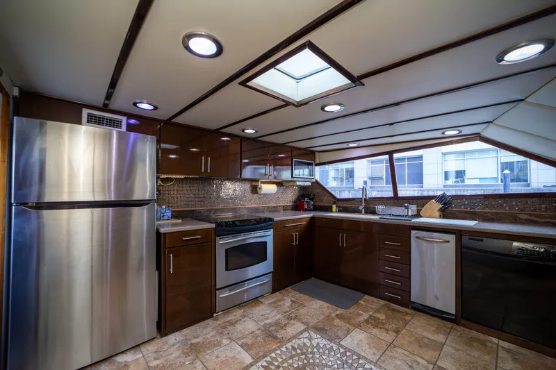 Slide: The Image of Luxurious kitchen interior on 1987 Guy Couach 97 yacht, featuring modern appliances and sleek design. - 28