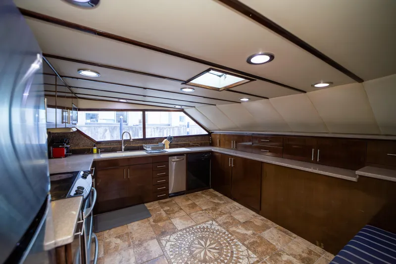 Slide: The Image of Luxurious kitchen interior on a 1987 Guy Couach 97 yacht, featuring modern appliances and elegant design. - 30