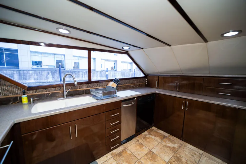 Slide: The Image of Luxurious kitchen interior on a 1987 Guy Couach 97 yacht, featuring modern cabinetry and ample counter space. - 31