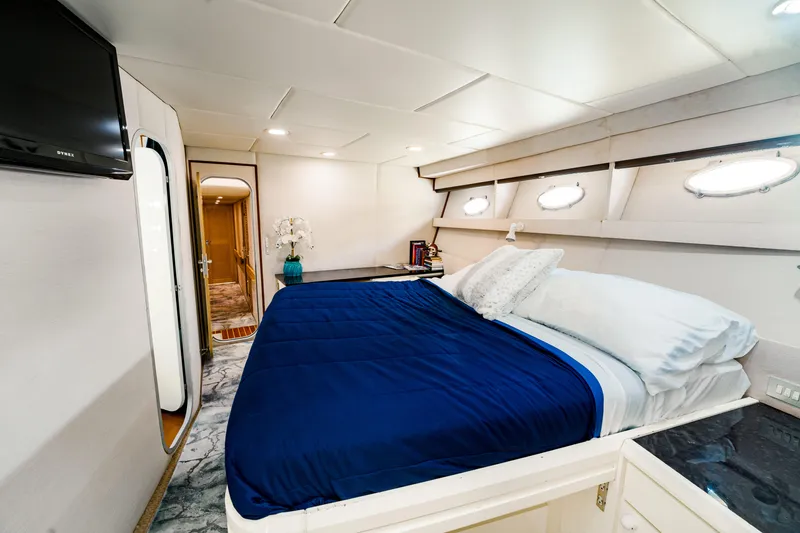 Slide: The Image of Luxurious bedroom interior of 1987 Guy Couach 97 yacht with blue bedding and modern decor. - 40