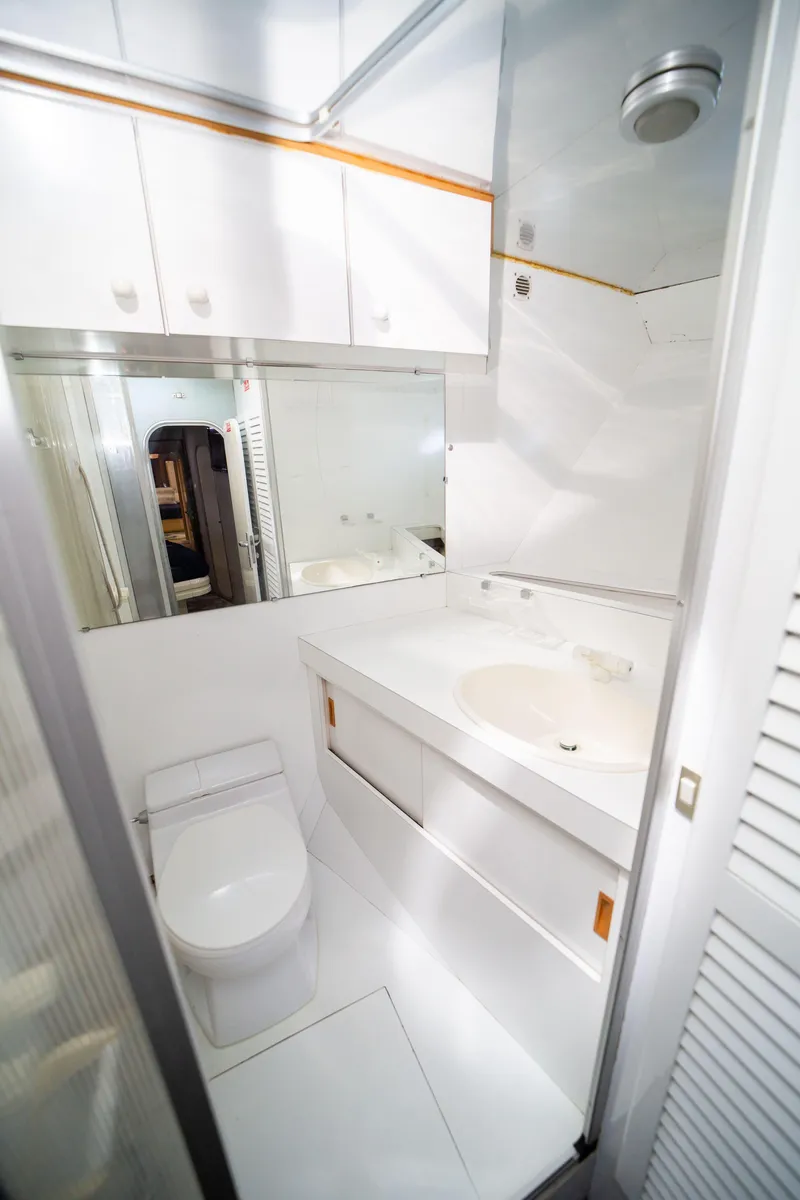 Slide: The Image of Luxurious bathroom in 1987 Guy Couach 97 yacht, featuring sleek white design and modern fixtures. - 45