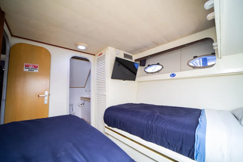 Slide: The Image of Interior cabin of 1987 Guy Couach 97 yacht with twin beds and TV. - 46