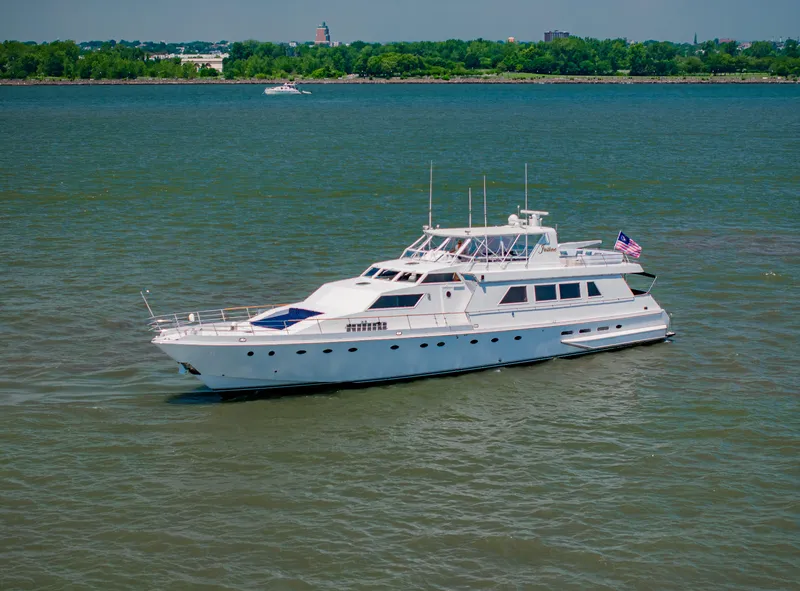 Slide: The Image of Luxury 1987 Guy Couach 97 yacht cruising on a calm river. - 6