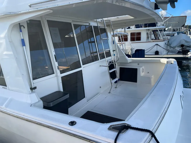 Slide: The Image of 2004 Meridian 490 Pilothouse yacht with spacious deck and modern design, docked at marina. - 11