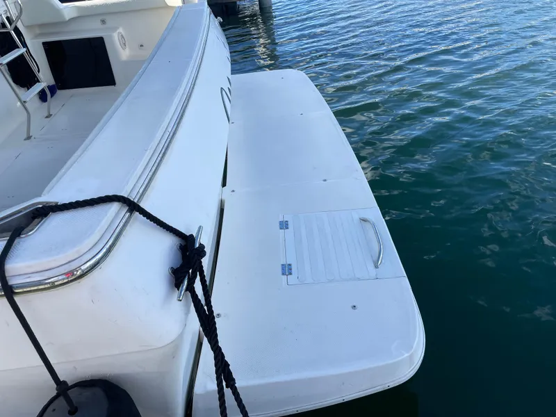 Slide: The Image of 2004 Meridian 490 Pilothouse swim platform on calm water. - 12