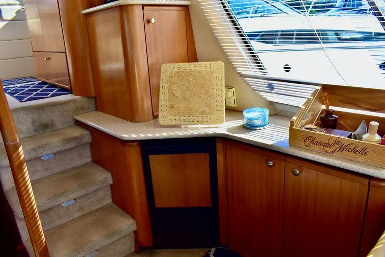 Slide: The Image of Interior of 2004 Meridian 490 Pilothouse with wooden cabinetry and carpeted stairs. - 19