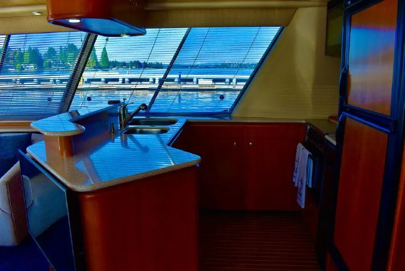 Slide: The Image of Interior of 2004 Meridian 490 Pilothouse yacht with kitchen and large windows. - 22