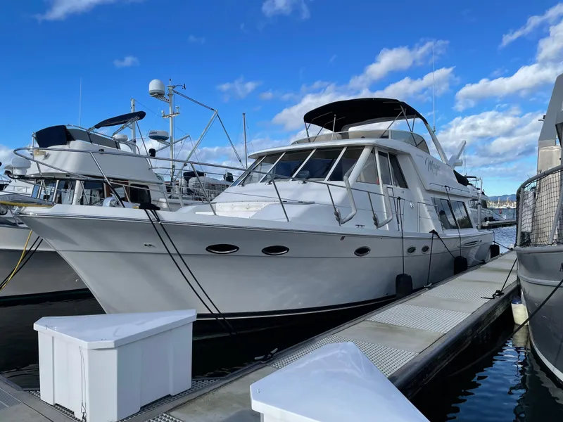 Slide: The Image of 2004 Meridian 490 Pilothouse yacht docked at marina under blue sky. - 6