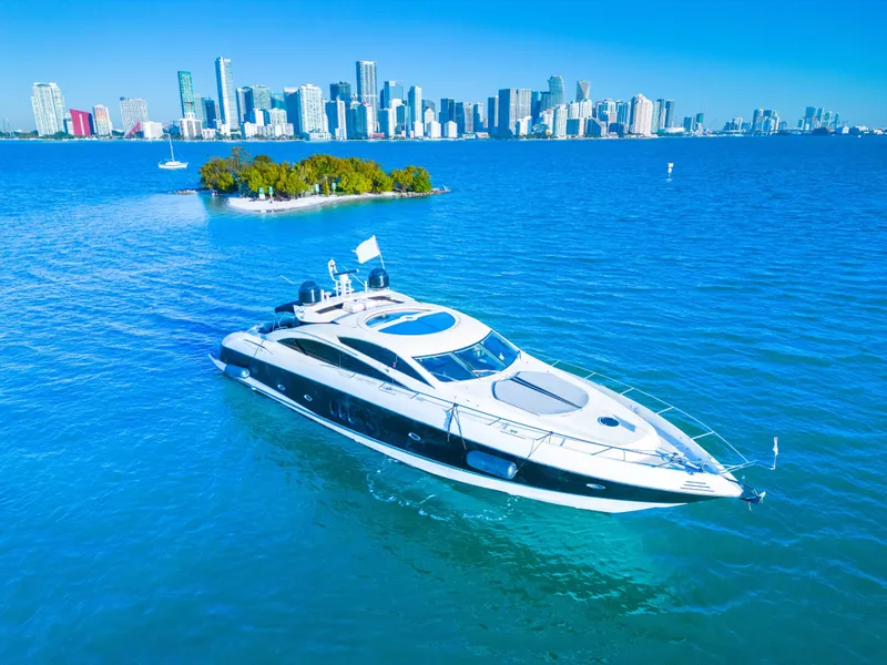 The Image of Luxury Sunseeker Predator 82 yacht cruising near city skyline, 2006 model. - 0