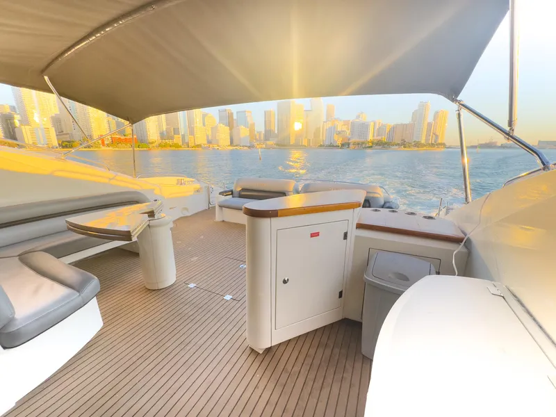 Slide: The Image of Luxurious 2006 Sunseeker Predator 82 yacht deck with city skyline view at sunset. - 10