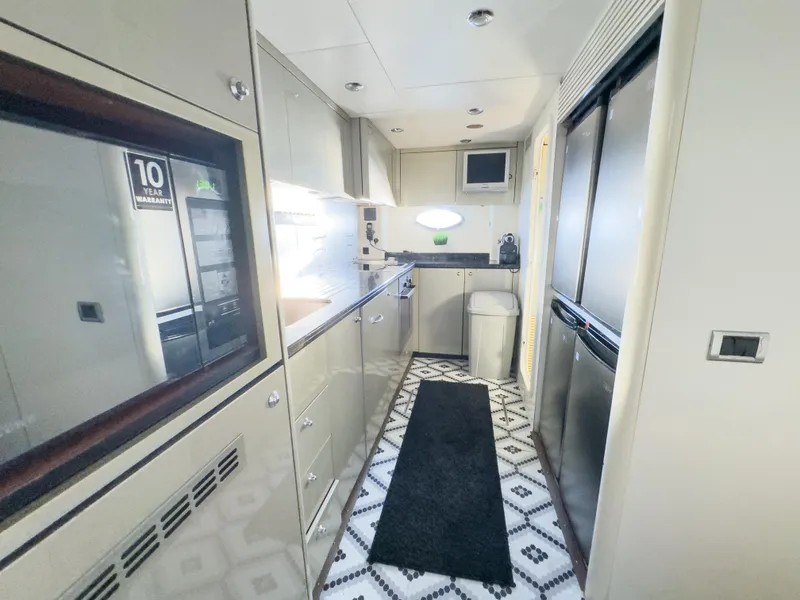 Slide: The Image of Modern kitchen interior of 2006 Sunseeker Predator 82 yacht, featuring sleek cabinetry and appliances. - 15
