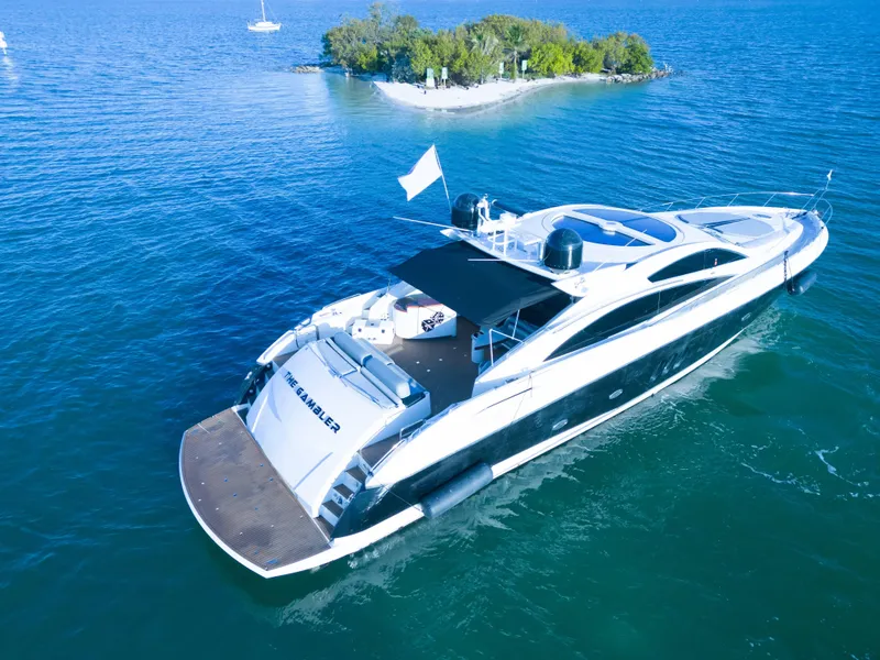 Slide: The Image of Sunseeker Predator 82 yacht cruising near a small island, 2006 model. - 3