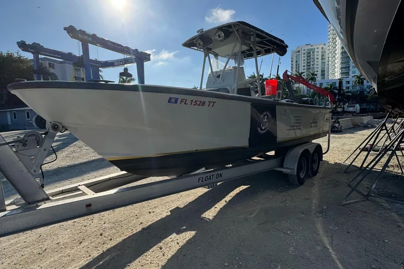 Slide: The Image of 2005 Boston Whaler Justice 240 on trailer in sunny marina setting. - 2