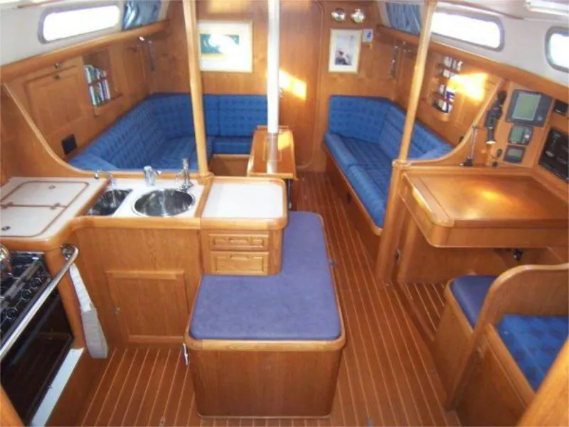 Slide: The Image of Interior of 2025 Rustler 42 yacht with wooden finish and blue seating. - 11
