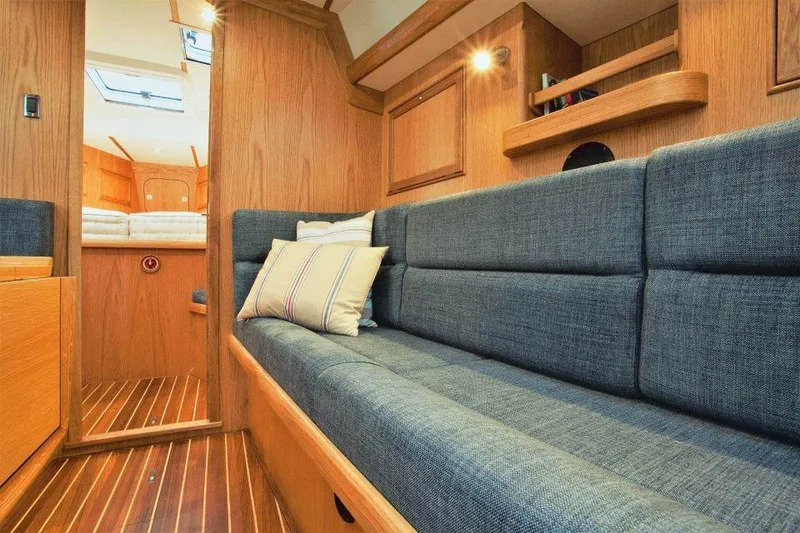 Slide: The Image of Luxurious interior of 2025 Rustler 42 yacht with wooden finish and comfortable seating. - 13