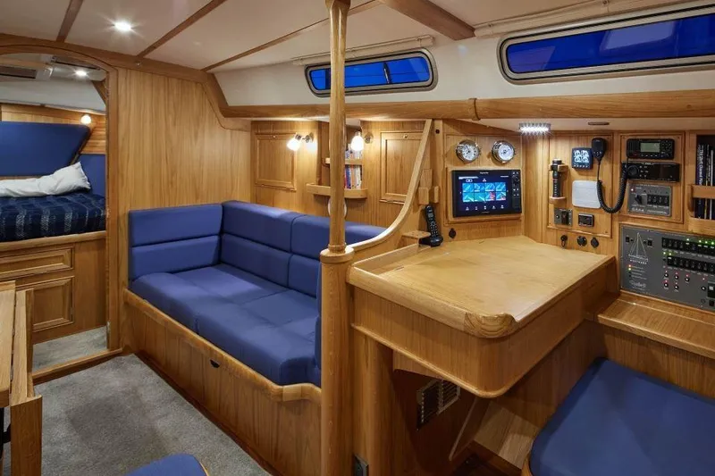Slide: The Image of Luxurious interior of 2025 Rustler 42 yacht with wooden finish and blue seating. - 15