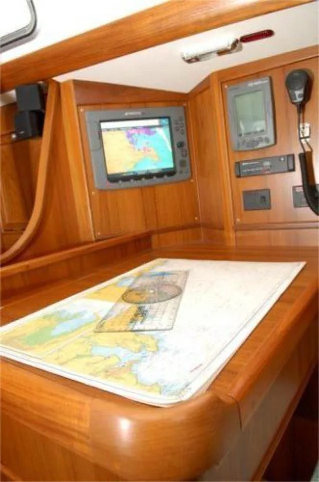 Slide: The Image of Navigation station on 2025 Rustler 42 yacht with map and electronic display. - 16
