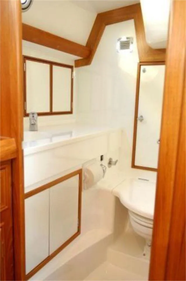 Slide: The Image of 2025 Rustler 42 yacht bathroom with wooden accents and modern fixtures. - 21