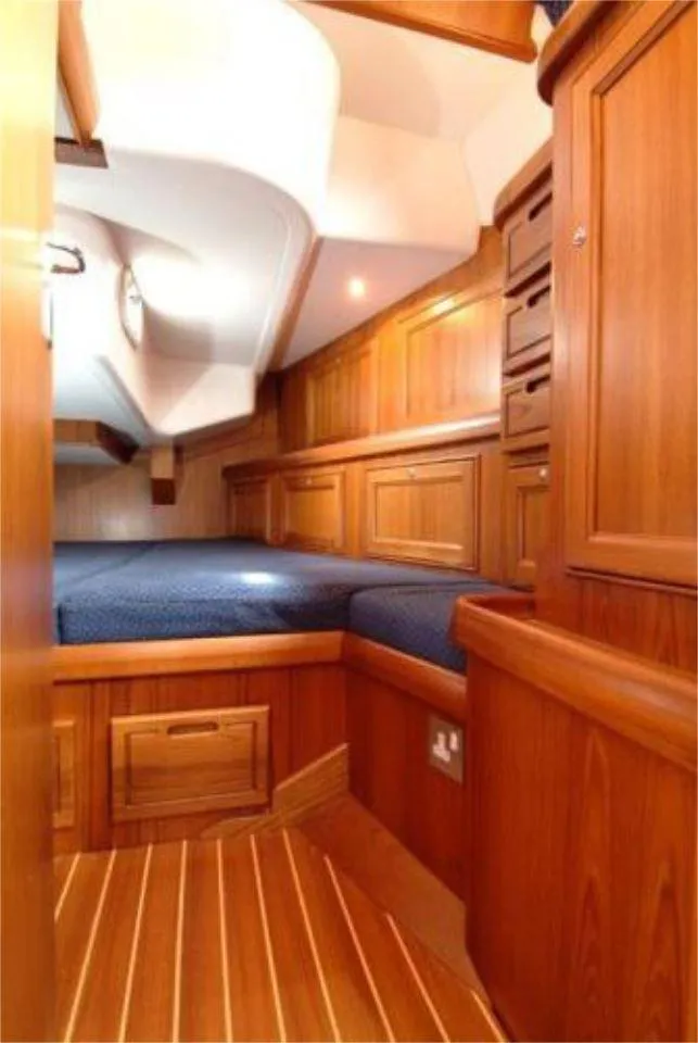 Slide: The Image of Luxurious cabin interior of 2025 Rustler 42 yacht with wooden finish and cozy bed. - 22