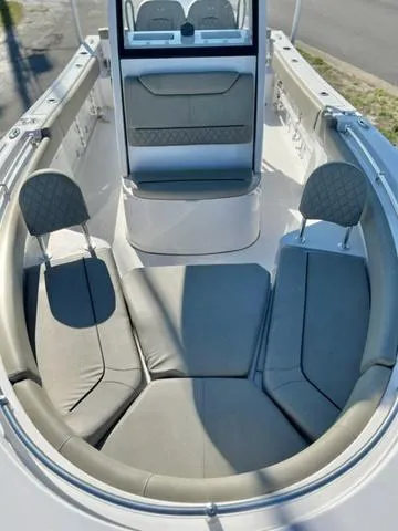 Slide: The Image of 2025 Sportsman Heritage 231 boat interior with cushioned seating and table. - 12