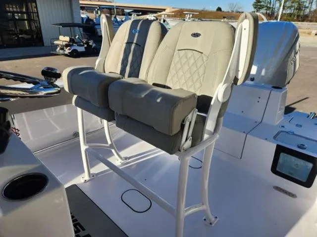 Slide: The Image of 2025 Sportsman Heritage 231 boat with Yamaha outboard engine, docked near a building. - 16