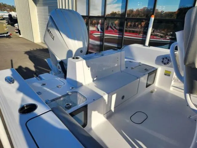 Slide: The Image of 2025 Sportsman Heritage 231 boat with Yamaha engine, docked near a building. - 21