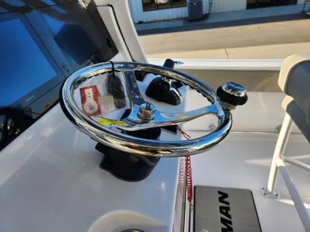 Slide: The Image of Steering wheel of 2025 Sportsman Heritage 231 boat, featuring modern controls and dashboard. - 22