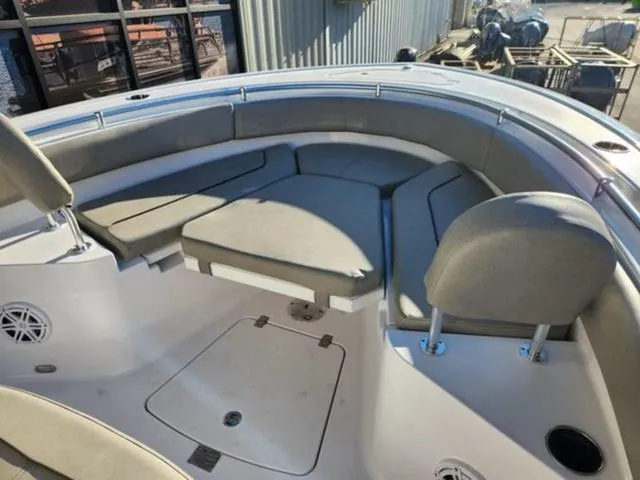 Slide: The Image of 2025 Sportsman Heritage 231 boat interior with cushioned seating and storage compartments. - 24