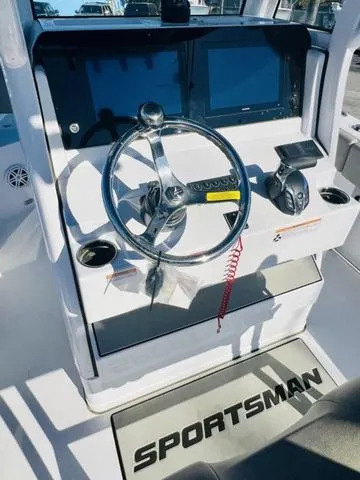 Slide: The Image of 2025 Sportsman Heritage 231 boat interior with cushioned seating and storage compartments. - 4