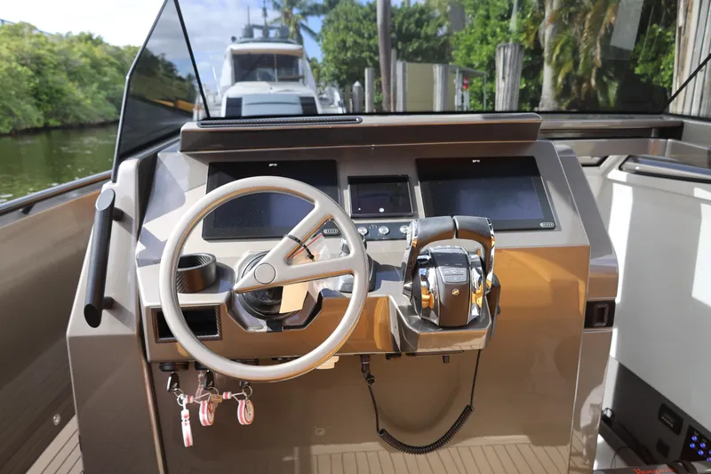Slide: The Image of 2021 Vanquish Yachts VQ40 helm with modern controls and steering wheel. - 18
