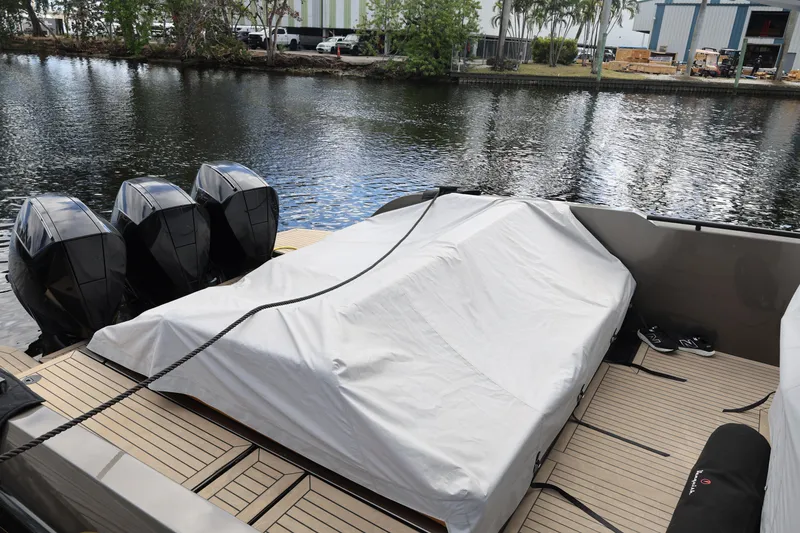 Slide: The Image of 2021 Vanquish Yachts VQ40 with covered deck and triple outboard motors. - 21